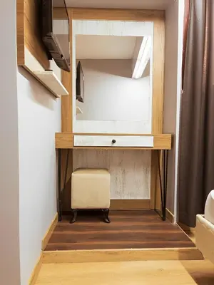 a small room with a chair and a mirror at The Lumina Hotel in Istanbul