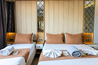 two beds in a room with towels on them at The Lumina Hotel in Istanbul