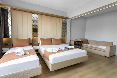 a bedroom with two beds and a couch at The Lumina Hotel in Istanbul