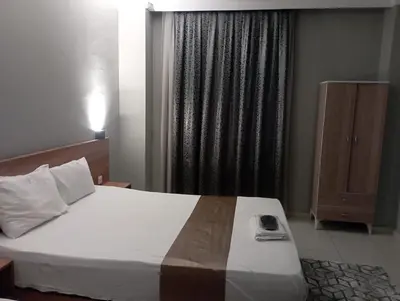 a bedroom with a large bed and a window at Rosse Hotel in Kırac