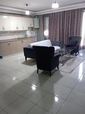 a living room with a bed and a table and chairs at Rosse Hotel in Kırac