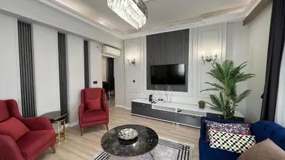 a living room with a couch and a tv at Taksim Square Luxury 4BR Next to Hotels Perfect for Families & Groups in Istanbul