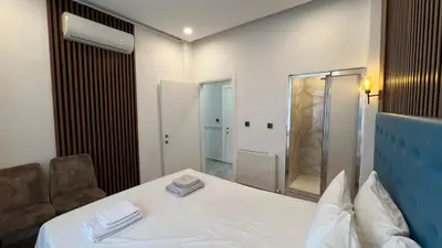 a room with a bed and a chair and a mirror at Taksim Square Luxury 4BR Next to Hotels Perfect for Families & Groups in Istanbul