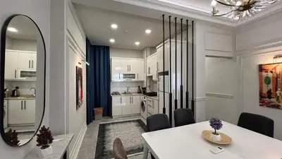 a kitchen and dining room with a table and a mirror at Taksim Square Luxury 4BR Next to Hotels Perfect for Families & Groups in Istanbul