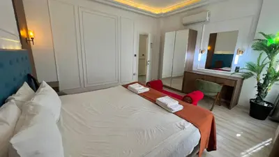 a bedroom with a bed with two towels on it at Taksim Square Luxury 4BR Next to Hotels Perfect for Families & Groups in Istanbul