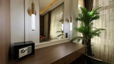 a room with a window with a clock and a palm tree at Taksim Square Luxury 4BR Next to Hotels Perfect for Families & Groups in Istanbul