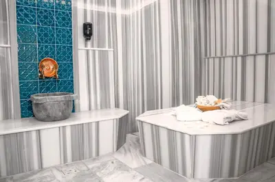 a bathroom with a table with towels on it at ivy Hotel Spa in Yalova