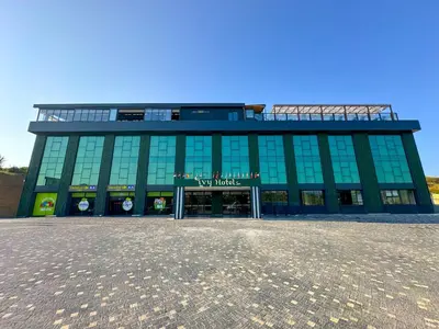 a large green building with a sign on it at ivy Hotel Spa in Yalova