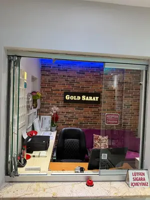 a store window with a gold salary sign on a brick wall at GOLD SARAY PANSİYOn in Saray