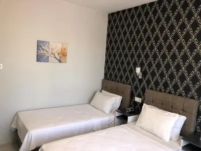 a room with two beds and a picture on the wall at GOLD SARAY PANSİYOn in Saray