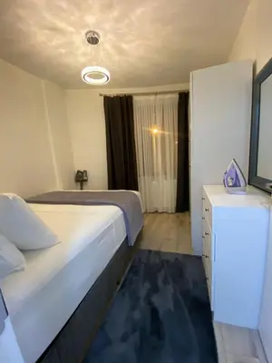 a bedroom with a large bed and a dresser with a mirror at Apartment - Little Hagia Sophia in Istanbul