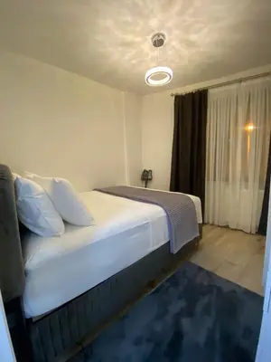 a bedroom with a large white bed and a window at Apartment - Little Hagia Sophia in Istanbul