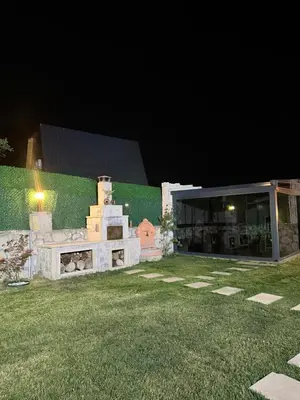 a stone fireplace in a yard at night at MedaSuite Stone House with Detached Pool in Kandıra