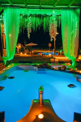 a swimming pool at night with green lights at MedaSuite Stone House with Detached Pool in Kandıra