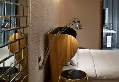 a lamp sitting on a table next to a bed at Witt Istanbul Suites in Istanbul