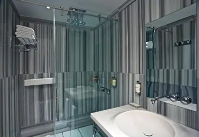 a bathroom with a sink and a glass shower at Witt Istanbul Suites in Istanbul