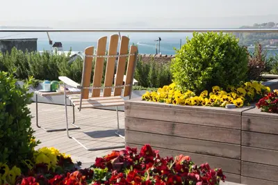 a patio with two chairs and flowers on a balcony at Witt Istanbul Suites in Istanbul