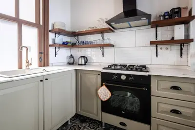 a kitchen with a stove and a sink at Chic 2BR Retreat House - Heart of Cihangir! #394 in Istanbul
