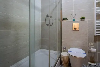 a bathroom with a shower and a toilet at Chic 2BR Retreat House - Heart of Cihangir! #394 in Istanbul