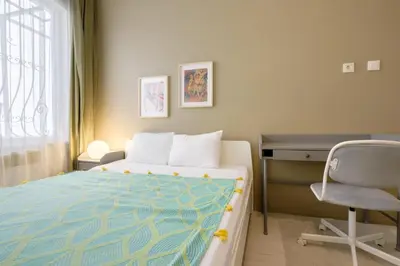 a bedroom with a bed and a desk and a chair at Chic Apartment Walk to Maçka Park Nişantaşı in Istanbul