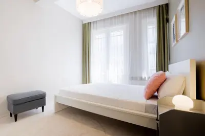 a bedroom with a bed and a window at Chic Apartment Walk to Maçka Park Nişantaşı in Istanbul