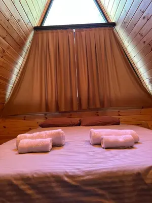 two pink pillows on a bed in a tent at Sapancasadembungalov in Sapanca