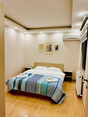 a bedroom with a bed with a striped blanket at Villa Casa Bianca in Sapanca