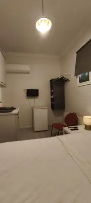 a room with a white bed and a table and chairs at Şişli Suites - Room23 in Istanbul