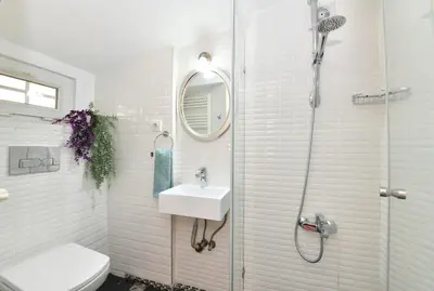 a white bathroom with a sink and a shower at Private Terrace AC Bright Flat Galata in Istanbul