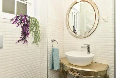 a bathroom with a sink and a mirror at Comfortable Bright Home AC Galata in Istanbul