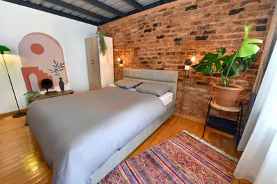 a bedroom with a bed and a brick wall at Cute Retro Home Balcony AC Galata in Istanbul