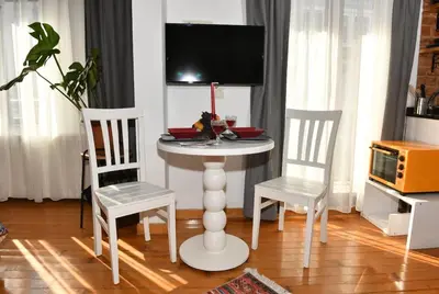 a table with two chairs and a tv on top at Cute Retro Home Balcony AC Galata in Istanbul