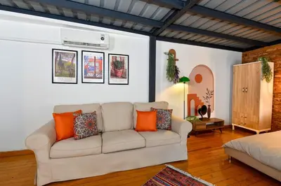 a living room with a couch and a bed at Cute Retro Home Balcony AC Galata in Istanbul