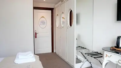 a hallway with a white door and a mirror at Galata Fil Hotel in Istanbul