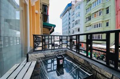 a balcony with a bench and a view of a city at Taksim Square 1 plus 1 fully equipped air conditioned luxury apartment in Istanbul