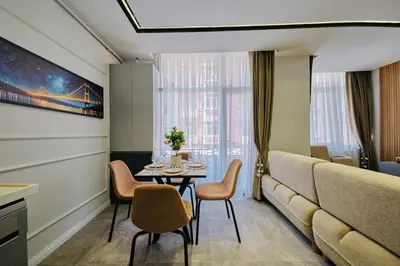 a living room with a table and chairs and a couch at Taksim Square 1 plus 1 fully equipped air conditioned luxury apartment in Istanbul