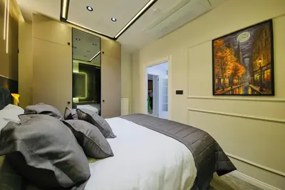 a bedroom with a bed and a painting on the wall at Taksim Square 1 plus 1 fully equipped air conditioned luxury apartment in Istanbul