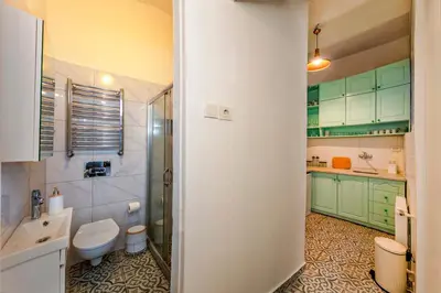 a bathroom with green cabinets and a toilet and a sink at The Heaven on Heritage Street in Istanbul
