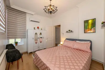 a bedroom with a bed and a chandelier at The Heaven on Heritage Street in Istanbul