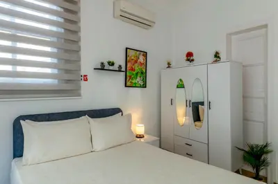a bedroom with a white bed and a white cabinet at The Heaven on Heritage Street in Istanbul