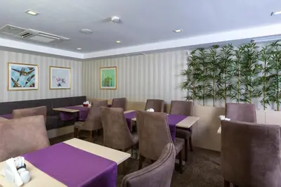 a dining room with purple tables and chairs at Molton Monapart Mecidiyekoy in Istanbul