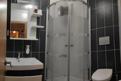 a bathroom with a shower and a toilet and a sink at family villas sapanca in Sapanca