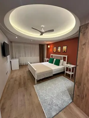 a bedroom with a bed and a ceiling at Heart of the City - Zey in Güzelce