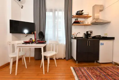 a small kitchen with a table and a table and chairs at Cute Flat Vintage Design AC Galata in Istanbul