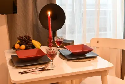 a table with a candle and wine glasses on it at Cute Flat Vintage Design AC Galata in Istanbul