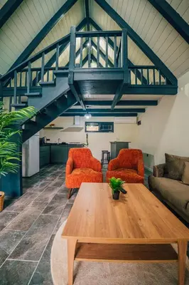 a living room with a wooden table and two chairs at MoonSA Boutique Villas in Sapanca