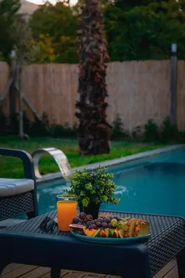 a tray of fruit on a table next to a pool at MoonSA Boutique Villas in Sapanca