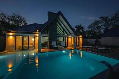 a swimming pool in front of a house at night at MoonSA Boutique Villas in Sapanca