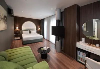a bedroom with a bed and a couch and a table at Hotel Bosfora in Istanbul