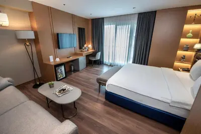 a hotel room with a large bed and a desk at Hotel Bosfora in Istanbul